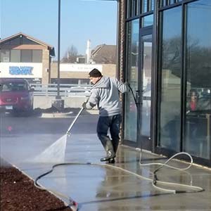 Photo of Powerhouse Pete cleaning concrete for a commercial storefront