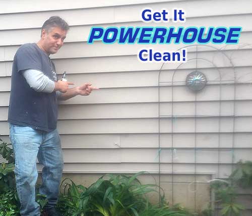 Photo of Powerhouse Pete pointing at freshly cleaned siding with text that says get it Powerhouse clean!