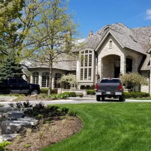 Photo of a luxury house with grass out front and recently cleaned windows and power washed sides