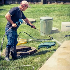 Photo of Powerhouse Pete power washing a concrete sidewalk