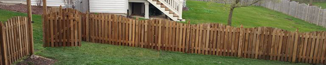 Photo of a long fence with a gate that was restored by Powerhouse