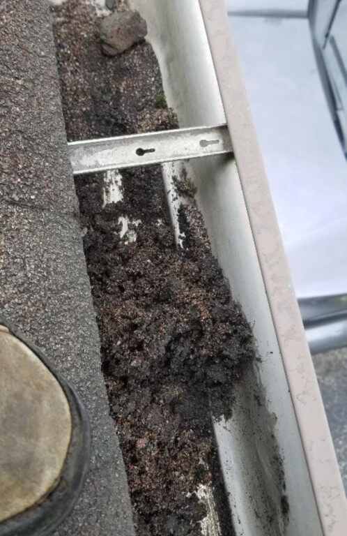 Photo of clogged gutter from sediment and debris