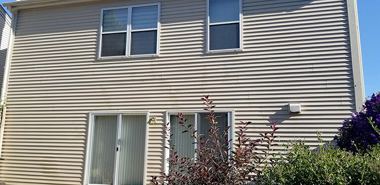 After photo of the back of a home with vinyl siding that was washed clean