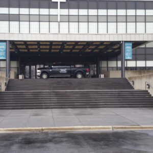 Photo of Pete's truck parked on top of the steps to a commercial building that was soft washed