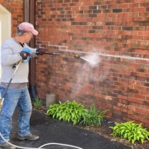 Photo of Powerhouse Pete cleaning a brick wall