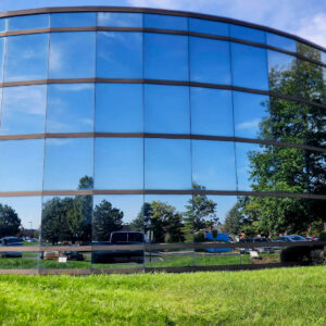 Photo of a commercial building windows reflecting the blue sky after being cleaning by Powerhouse