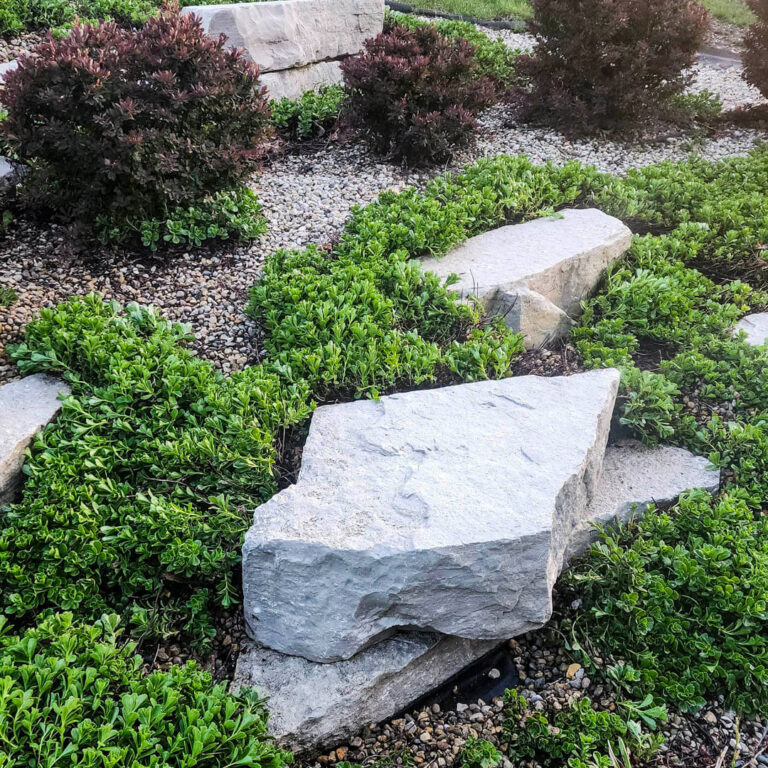 Photo of decorative brick paver boulders after being power washed