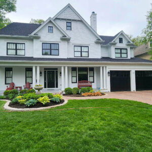 Photo of a house, garden, yard, and driveway. House, brick pavers, driveways, and siding was recently cleaned by Powerhouse