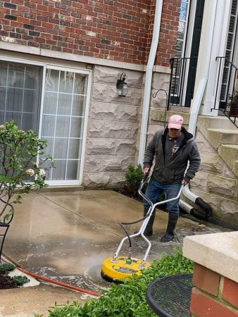 Photo of Powerhouse Pete hot washing a residential concrete patio