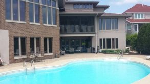 Photo of a building with a pool in front of it