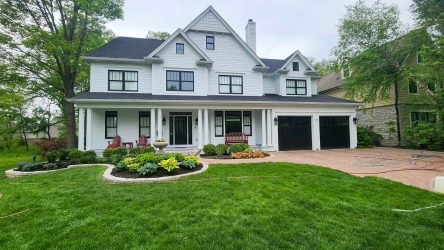 Photo of a house, garden, yard, and driveway. House, brick pavers, driveways, and siding was recently cleaned by Powerhouse