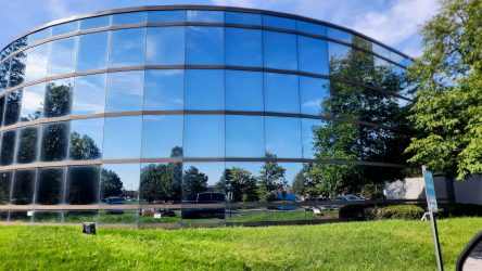 Photo of a commercial building windows reflecting the blue sky after being cleaning by Powerhouse